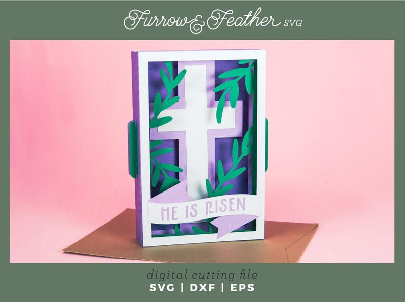 May include: A white cross with green leaves is framed in a purple and white frame. The frame has a banner at the bottom that reads "HE IS RISEN".