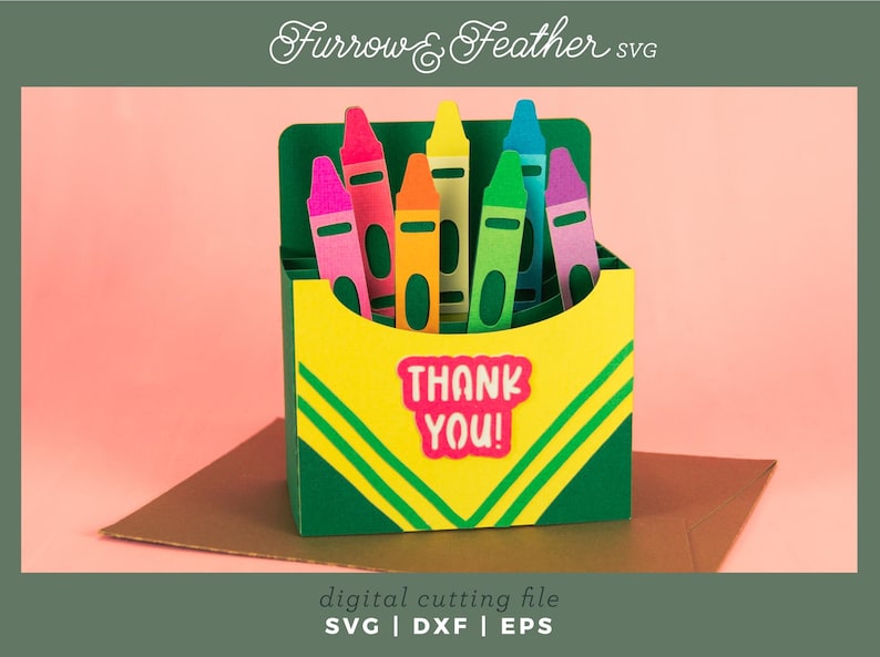 May include: A green box with a yellow and green striped design. The box is filled with colorful crayons and has the words "THANK YOU!" on the front.