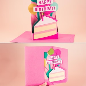 May include: A pink pop-up card with a cake and balloons. The card reads "Happy Birthday!"