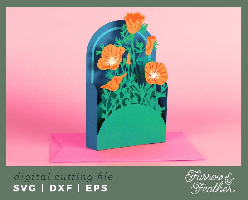May include: A digital cutting file for a pop-up card featuring a bouquet of orange California poppies in a blue archway. The card is on a pink surface. The text "Furrow & Feather" is in the bottom right corner.
