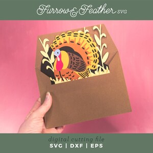 May include: A brown paper envelope with a colorful turkey design. The turkey has a yellow, orange, and brown tail, with a red wattle and blue head. The text "Furrow & Feather SVG" is at the top. The bottom text reads "digital cutting file SVG | DXF | EPS".