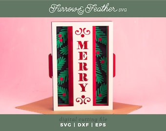 May include: A layered paper Christmas decoration with the word "MERRY" in red. The design includes green leaves and red berries on a black background, framed in white. The text "Furrow & Feather SVG" and "digital cutting file SVG | DXF | EPS" are also present.