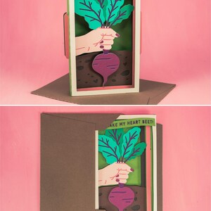 May include: A papercraft card with a pop-up design featuring a hand holding a beet with the text "You make my heart beet!"