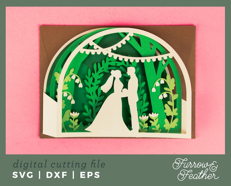 May include: A white silhouette of a couple standing in a green forest with white flowers and string lights. The image is a digital cutting file for a wedding card.