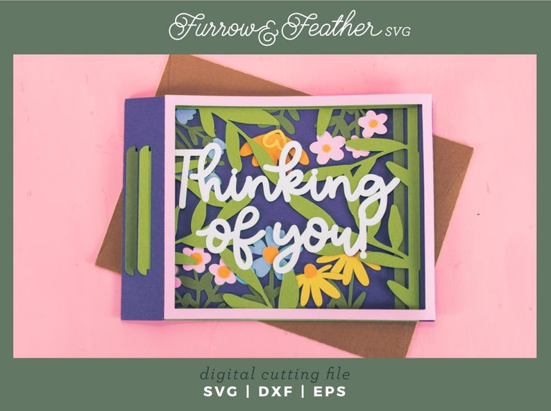 May include: A paper card with the words "Thinking of You" in white script, surrounded by colourful flowers and leaves. The card is set against a pink background, with the text "digital cutting file" and file type abbreviations at the bottom.