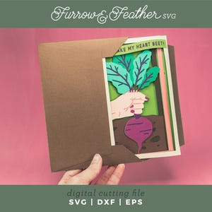 May include: A paper craft card with a layered design of a hand holding a beet with green leaves. The card has the text "Take my heart beet!" on it.