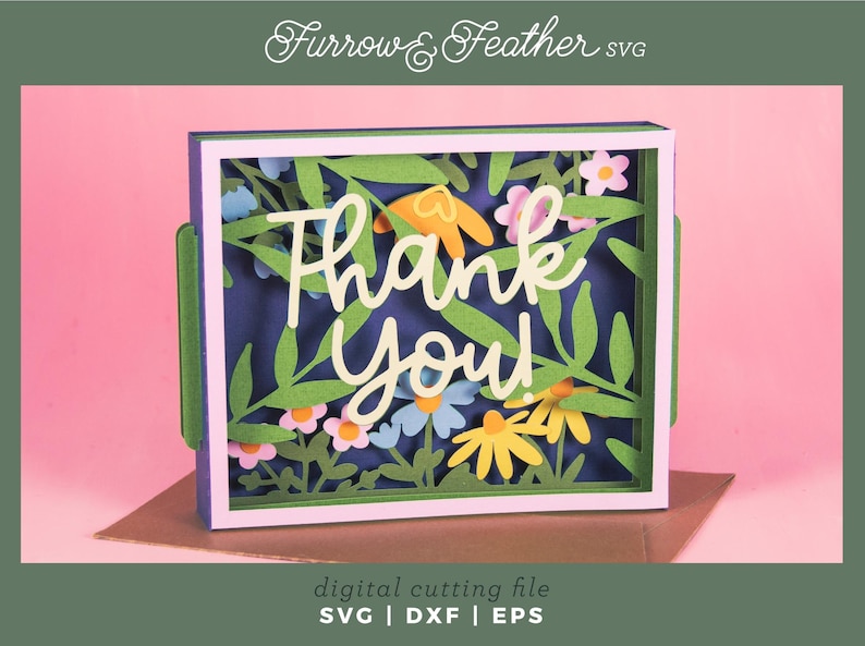 May include: A layered paper art card with the words "Thank You" in white script, surrounded by colorful paper flowers and green leaves. The card is set against a dark blue background and framed in white. The words "digital cutting file" and file formats are also visible.