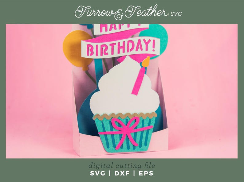 May include: A digital cutting file for a birthday card featuring a cupcake with a pink bow and the words "Happy Birthday!" in a banner.