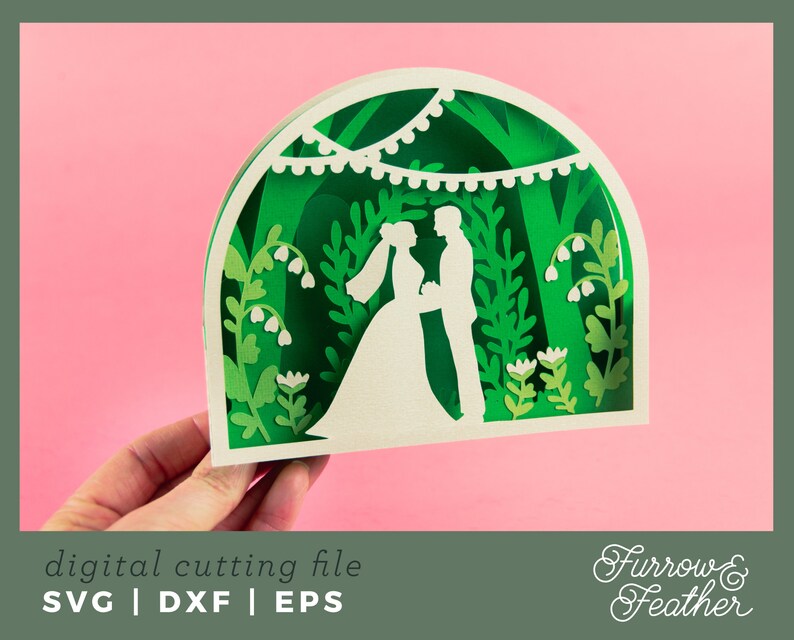 May include: A digital cutting file design featuring a wedding couple standing under a leafy archway with a string of lights. The design is in a green and white color scheme and includes floral details.