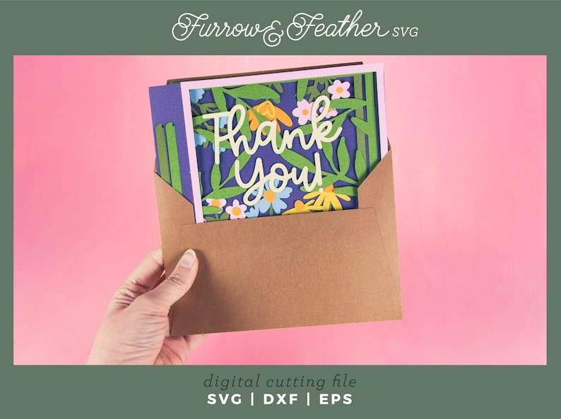 May include: A brown envelope holds a floral "Thank You" card with a blue background. The card features white script and colorful flowers. The image has a pink background and the text "Furrow & Feather SVG" at the top.