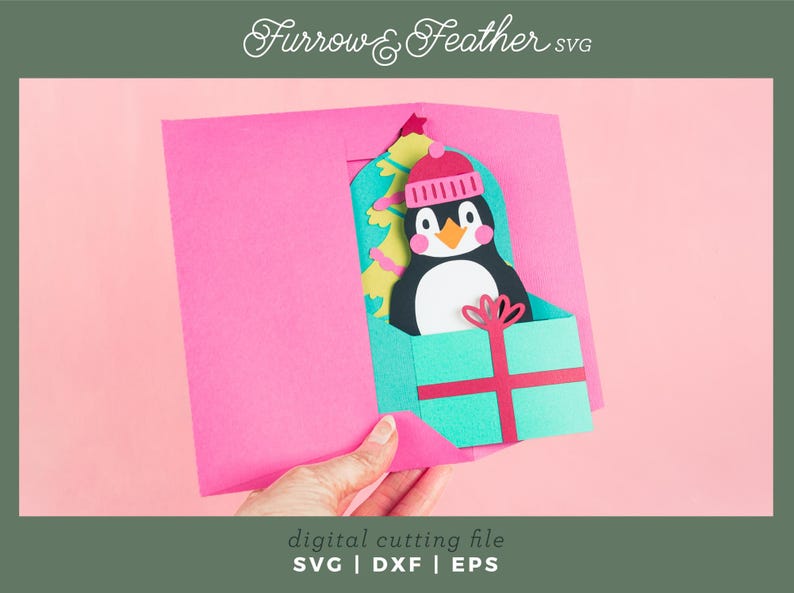 May include: A pink card with a pop-up penguin wearing a red and white hat. The penguin is holding a green and red gift box. The card says "Furrow & Feather svg" at the top and "digital cutting file SVG | DXF | EPS" at the bottom.