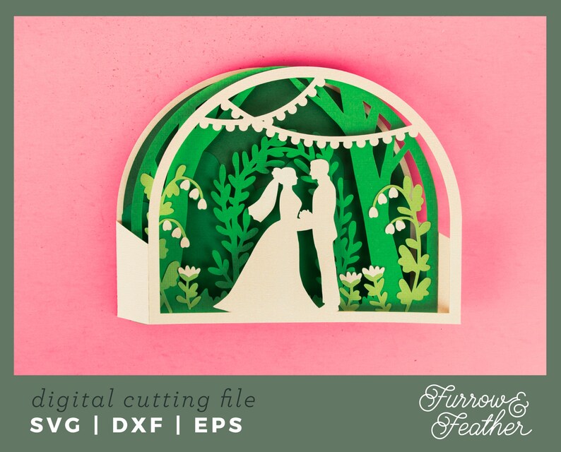 May include: A white paper cut-out design of a wedding couple standing under a green leafy archway with white flowers and string lights. The design is on a pink background. The text "Furrow & Feather" is in the bottom right corner.