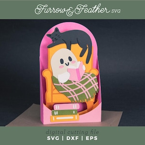 May include: A papercraft scene featuring a ghost reading a book while seated in an orange chair, covered by a green and white plaid blanket. A black cat rests above. The text "Furrow & Feather SVG" and "digital cutting file SVG | DXF | EPS" are also visible.