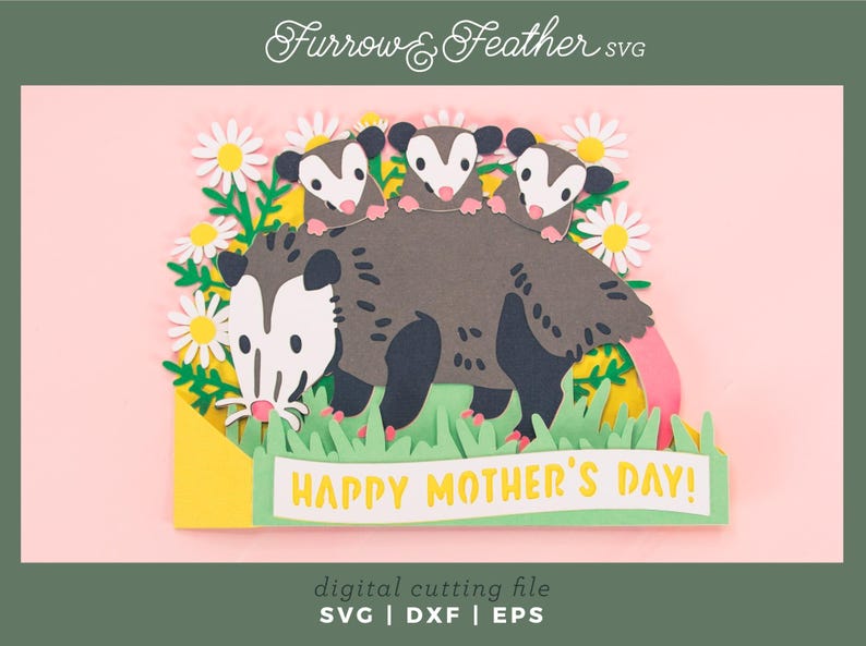 May include: A papercraft illustration of a mother opossum with three babies, daisies, and grass. The banner reads "HAPPY MOTHER'S DAY!". The image is labeled "Furrow & Feather SVG". A digital cutting file is also mentioned.