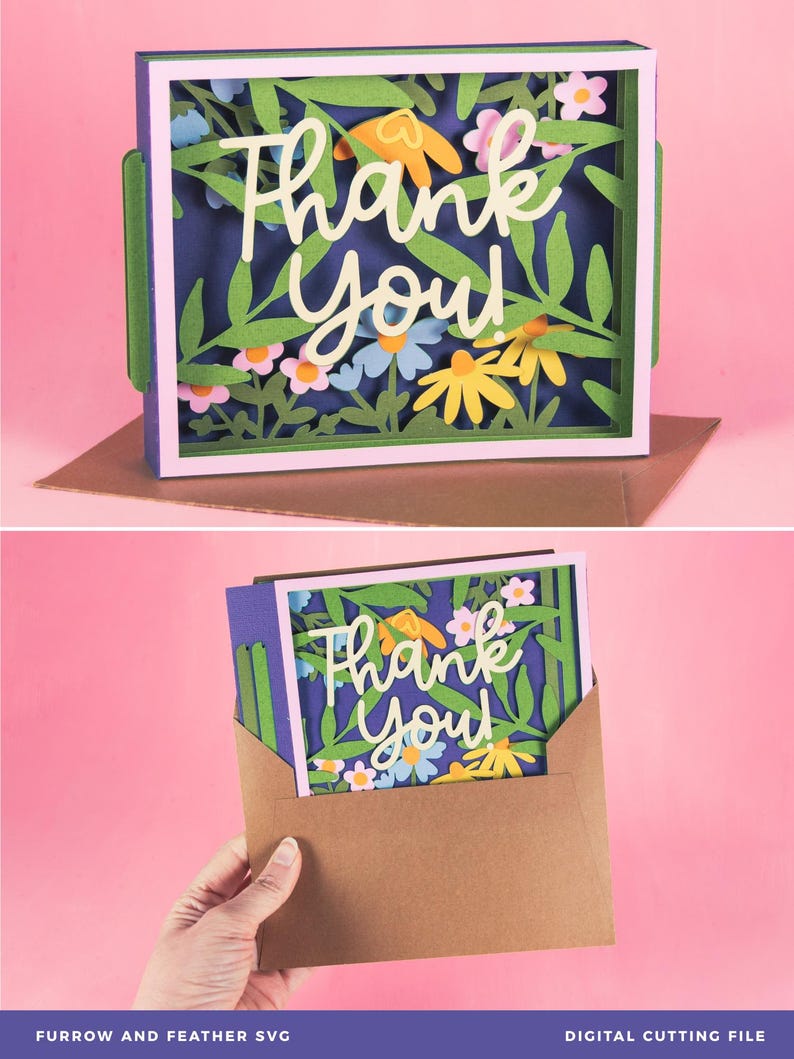 May include: A layered paper art card with a floral design and the words "Thank You" in white script. The card features green leaves, and colorful flowers in a white frame. The card is inside a brown envelope.