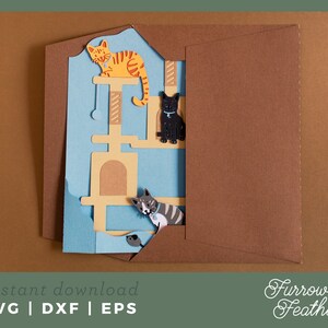 May include: A digital cut file design of a cat tree with three cats. The cats are orange, black, and gray. The design is in a blue and brown envelope. The text "instant download SVG | DXF | EPS" is at the bottom of the image. The text "Furrow & Feather" is at the bottom right of the image.