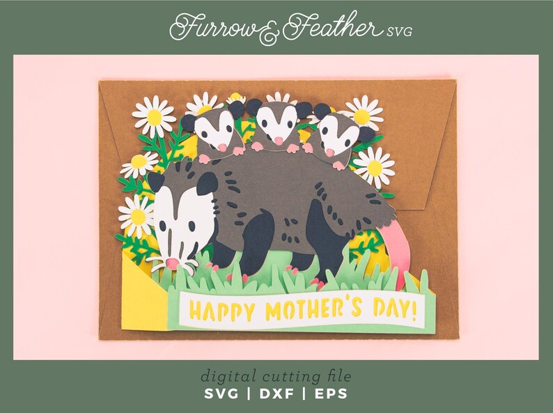 May include: A papercraft Mother's Day card depicting a mother opossum with three babies, daisies, and grass. The card has the text "HAPPY MOTHER'S DAY!" in yellow. The design is a digital cutting file.