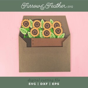 May include: A papercraft design of sunflowers in a brown envelope. The sunflowers have yellow petals and brown centres, with green leaves. The envelope is brown, set against a pink background. Text at the top reads "Furrow & Feather SVG".