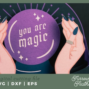 May include: A purple papercraft magic eight ball with the text "you are magic" inside. The eight ball is held by two papercraft hands with dark blue fingernails.
