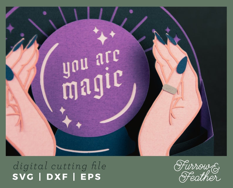 May include: A purple papercraft magic eight ball with the text "you are magic" inside. The eight ball is held by two papercraft hands with dark blue fingernails.
