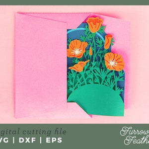 May include: A pink envelope with a cut-out design of orange poppy flowers and green leaves. The design is layered and appears to be three-dimensional. The text "Furrow & Feather" is visible in the bottom right corner.