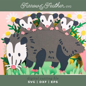 May include: A papercraft design showing a mother opossum with three babies, set amongst daisies and grass. The opossums are grey with white faces and pink paws. The image includes the text "Furrow & Feather SVG" and "digital cutting file".
