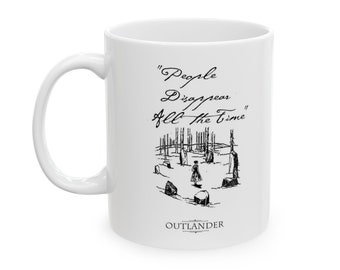 May include: White ceramic mug with a black and white illustration of a scene from the TV show "Outlander". The text "People Disappear All the Time" is written in cursive above the illustration. The word "Outlander" is written in all caps below the illustration.