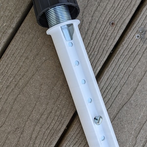 May include: A white plastic extension pole with a black plastic cap and a metal spring inside. The pole has a series of holes along the side.