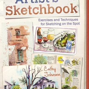 May include: An "Artist's Sketchbook" with the title in blue and brown. The book features watercolor sketches of buildings, food, and birds. The cover includes the text "Exercises and Techniques for Sketching on the Spot."