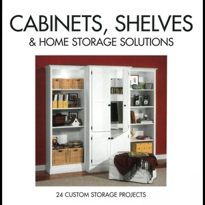 May include: White cabinets and shelves with storage baskets and decorative items. The image includes the text "CABINETS, SHELVES & HOME STORAGE SOLUTIONS" and "24 CUSTOM STORAGE PROJECTS". The cabinets have a variety of storage options.