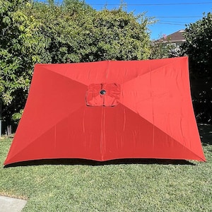 May include: A red rectangular patio umbrella with a black center pole.