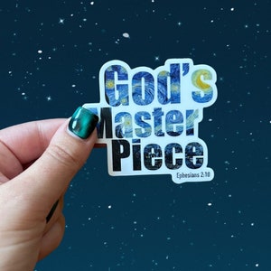 May include: A white sticker with the words "God's Masterpiece" in black text. The words are filled with a blue and white starry night painting. The sticker also includes the text "Ephesians 2:10" in black text.