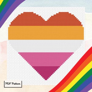 Könnte beinhalten: Ein Kreuzstichmuster eines Herzens in den Farben der lesbischen Pride-Flagge. Das Herz besteht aus orangefarbenen, gelben, weißen, rosa und roten Quadraten.
