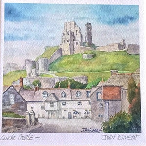 May include: Watercolor painting of Corfe Castle, a historic landmark, set against a green hill and a cloudy sky. The foreground shows a village with white buildings and red-tiled roofs. The artist's signature is visible.