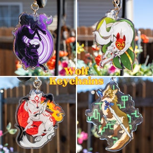 May include: Four different wolf-themed keychains. The first keychain features a black wolf with a purple and white swirl design. The second keychain features a white wolf with a red mask and a green leafy design. The third keychain features a white wolf with a red and orange swirl design. The fourth keychain features a green wolf with a blue sword and a green and white geometric design. All keychains are made of clear acrylic.