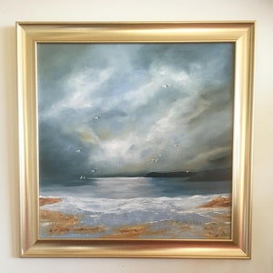 May include: A framed painting depicting a seascape with a cloudy sky and a calm sea. The painting is in shades of blue, grey, and white, with touches of gold. The artist's signature, "R. Blackler", is visible in the bottom right corner.