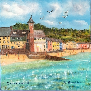 May include: A painting depicting a seaside town with colourful buildings, a clock tower, and a sandy beach with people. The sky is blue with white clouds and there are seagulls flying overhead. The painting is signed "R. Blackler" and titled "Cawsand".