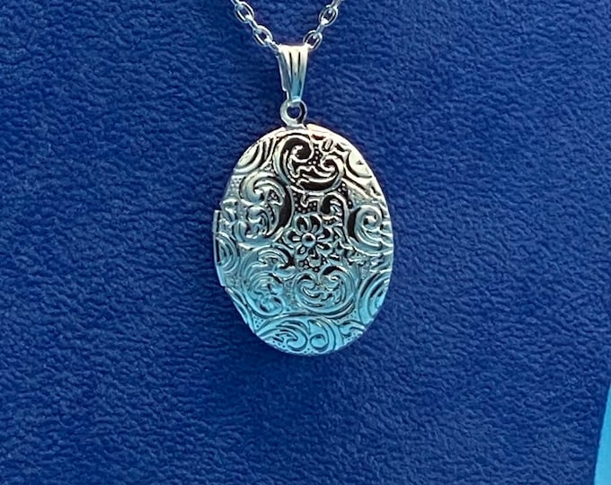 Bright Silver Oval Photo Locket in a Traditional Victorian Style Floral Design with Necklace.
