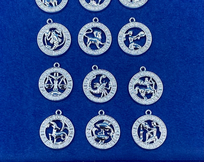 Bright Silver Astrology Symbols Set of Twelve  Zodiac Star Sign Round Charms with Cut Out Detail - Set of Twelve.