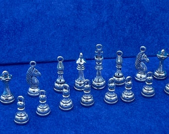 A Set of Silver Chess Pieces Charm and Pendants  - Set of Sixteen