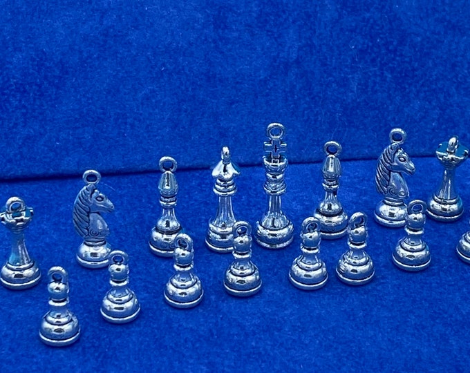 A Set of Silver Chess Pieces Charm and Pendants  - Set of Sixteen