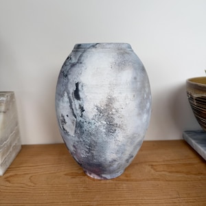 May include: A trio of ceramic mugs with a speckled, matte finish in cream, light brown, and dark brown. Each mug features a simple, minimalist design, ideal for tea or coffee.