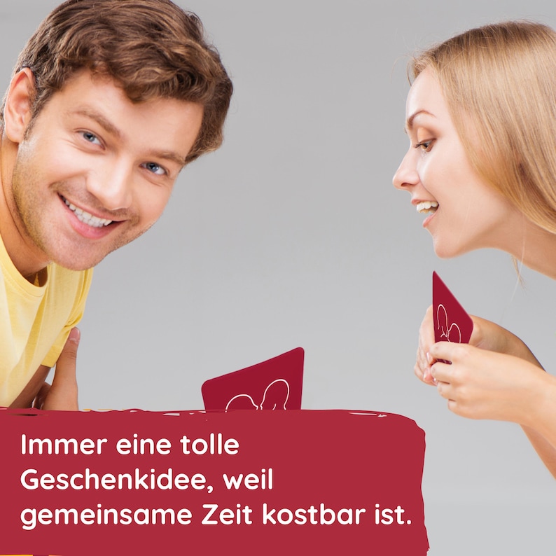 May include: Two people are playing a card game. The cards are red and have a white silhouette of two people on them. The text on the bottom of the image reads "Immer eine tolle Geschenkidee, weil gemeinsame Zeit kostbar ist."