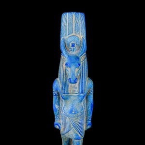 May include: A blue ceramic statue of an Egyptian god with a bull's head, wearing a headdress and a skirt.