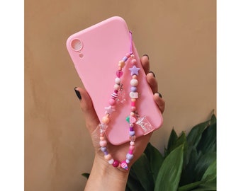 Elegant phone strap with purple and pink beads and charms. The thread is elastic and very resistant, 20cm long. I can enter a name.