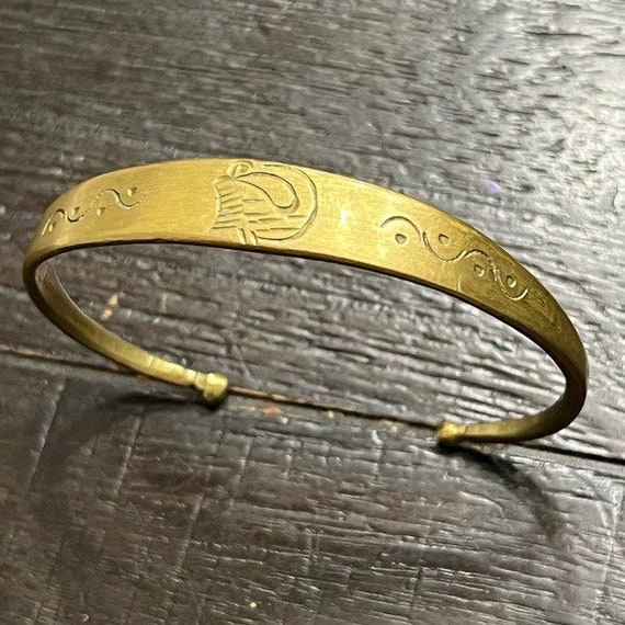 Etched brass cuff bracelet with open bottom. Lovel