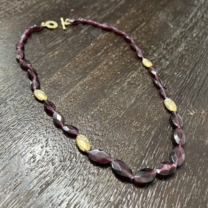 Monet vibrant purple glass bead necklace with gold jeweled accents. Thick t-clasp. 9 inches in length.