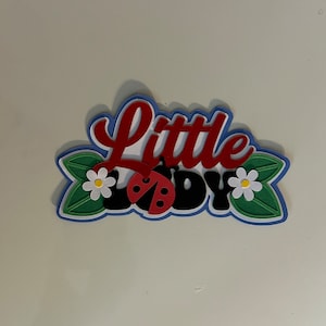 Titolo dell'album di ritagli "Little Lady Ladybug" con fustella in carta forata