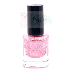 May include: A bottle of pink glitter nail polish with a black cap. The label on the cap reads "Pure Piggies Polish" and "10-Free, Vegan + Cruelty Free".
