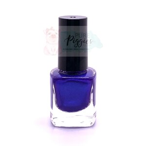 May include: A bottle of deep blue nail polish with a black cap. The label reads "Pure Piggies Polish" and "10-Free, Vegan, Cruelty-Free".